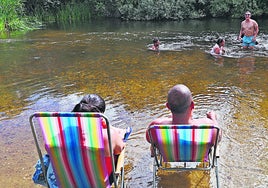 El calor invita a un grupo de bañistas a darse un chapuzón en el Tormes, a pesar de que el baño en la zona no está autorizado.