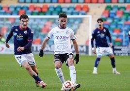 Alvarito con el balón en su poder mientras es presionado por dos jugadores del Deportivo Fabril.