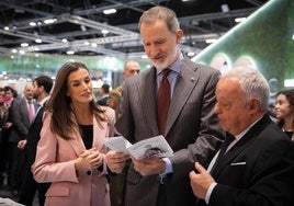 Los reyes y el consejero Gonzalo Santonja, en el stand de Fitur.