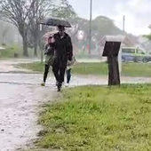 Imagen de varias personas resguardándose de las lluvias.