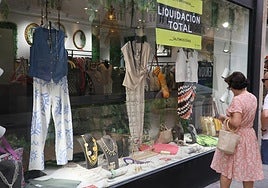 Dos personas, observando el escaparate de una tienda de calle Toro.