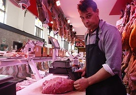 Un carnicero del Mercado Central, cortando un pedazo de ternera.