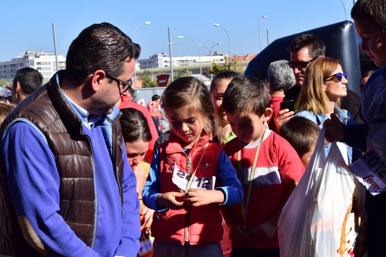 Los pequeños corredores recogen sus medallas en la prueba ¡Por mi colegio!