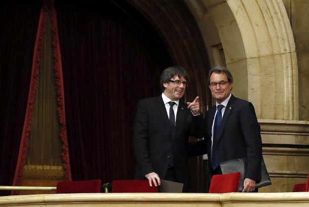 Puigdemont y Mas conversan tras el pleno del Parlament del pasado martes. :: Alberto Estévez / efe
