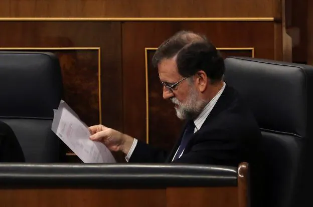 Rajoy lee un folio durante la sesión de control. :: Zipi / efe