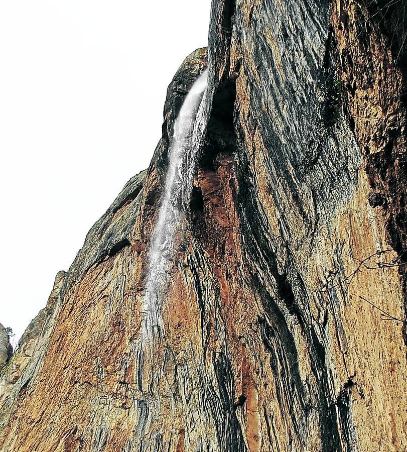 Imagen principal - Arriba, el chorrón este de Pueña Puerta. Abajo a la izquierda, Peña Puerta, murallón calizo en el nacimiento del arroyo de Madre, al sur de Viguera. Abajo, el chorrón oeste.