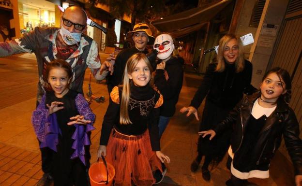 Un grupo de padres y sus hijos disfrutan de Halloween.