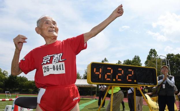 Hidekichi Miyazaki imita el gesto de Usain Bolt junto a la marca que acreditaba su récord. 