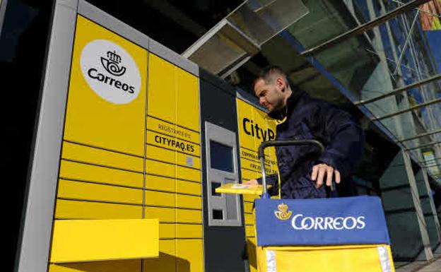 Un repartidor de Correos en una de sus máquinas Citypaq en Madrid