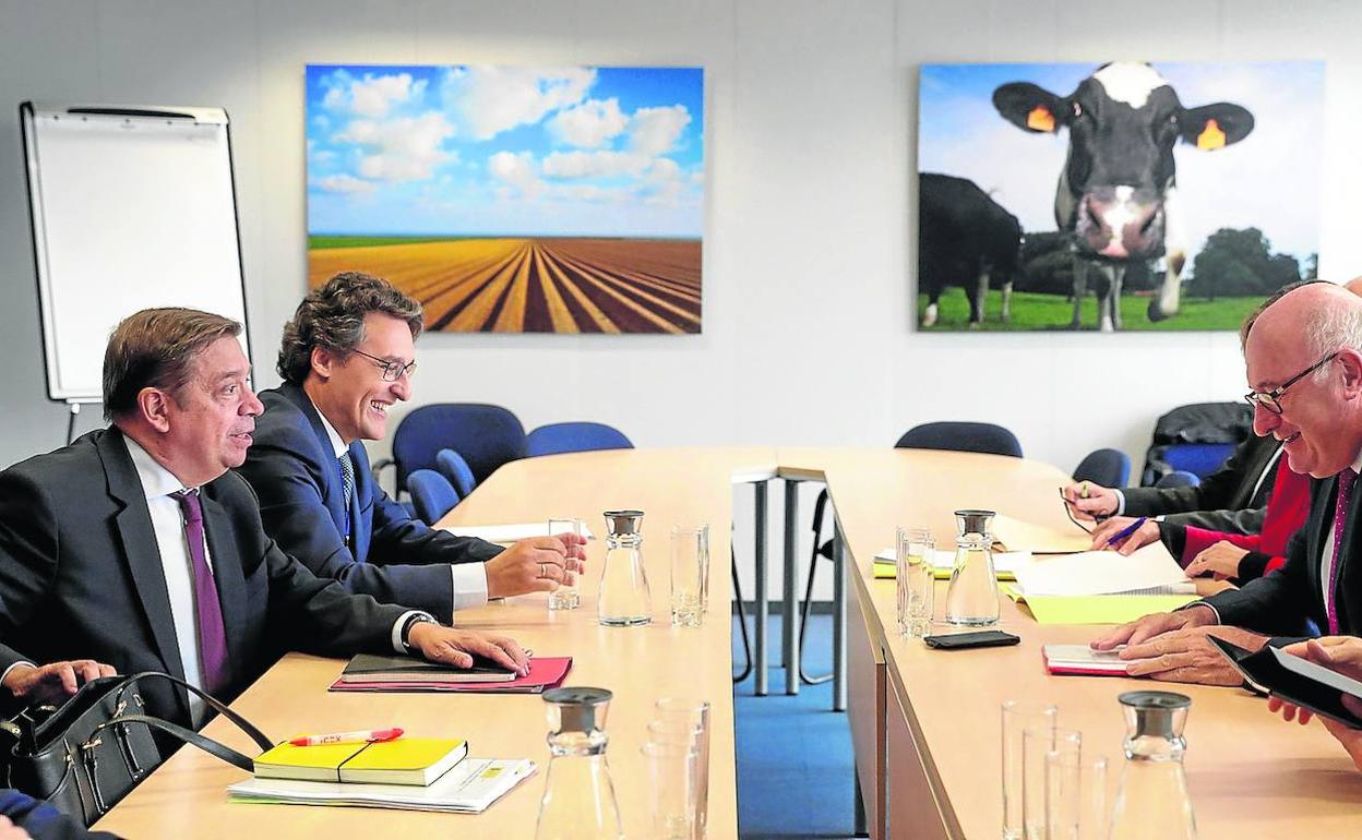 Luis Planas (primero por la izquierda), durante su reunión ayer con el comisario de Agricultura, Phil Hogan