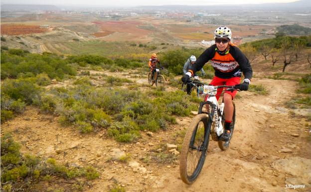 Ciclistas subiendo una senda en la Travesía del Mantible del domingo, al fondo Logroño