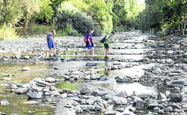 El río Oja con sus mullidas riberas, que junto a las terrazas dos de los espacios más frecuentados por cuantos recalan en Ezcaray estos días. albo