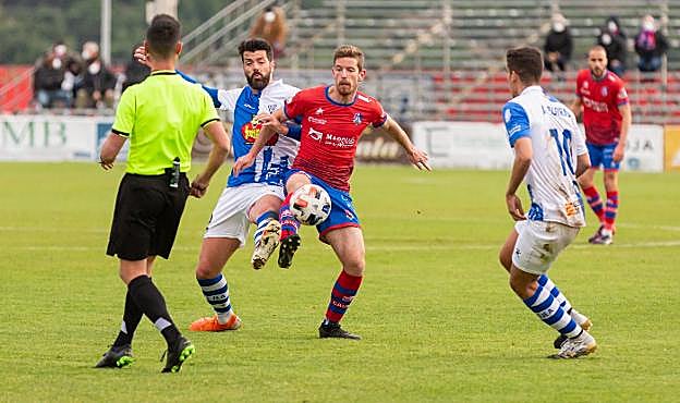 Tarsi pugna con dos jugadores del Ejea en el último partido de liga jugado en La Planilla. 