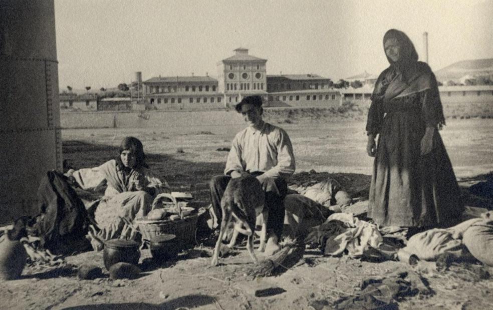 1935. Una familia de zíngaros, con ell antiguo matadero al fondo. 