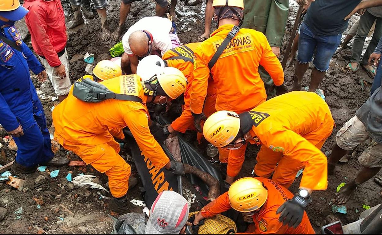 Los equipos de rescate recuperan los cuerpos de las víctimas de las riadas en Indonesia.