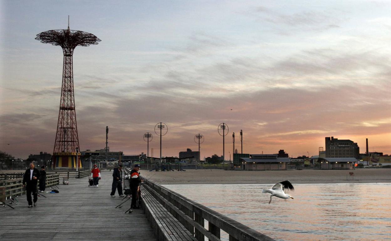 Un grupo personas transita por el histórico paseo de Coney Island. 