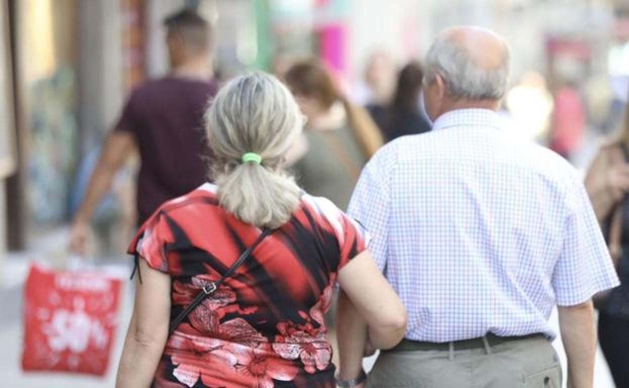 Dos jubilados paseando por la calle.