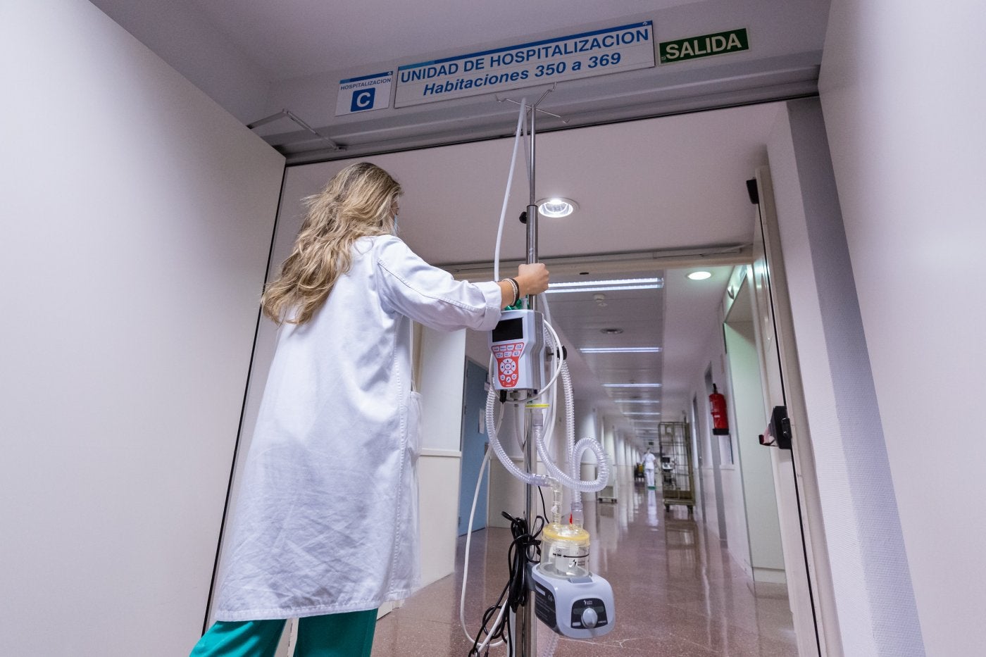 Una profesional se dirige a una de las alas de hospitalización de la planta tercera con algunos de los aparatos usados en los tratamientos respiratorios. 