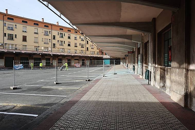 Operarios señalizando las plazas de un aparcamiento que se anuncia como provisional.