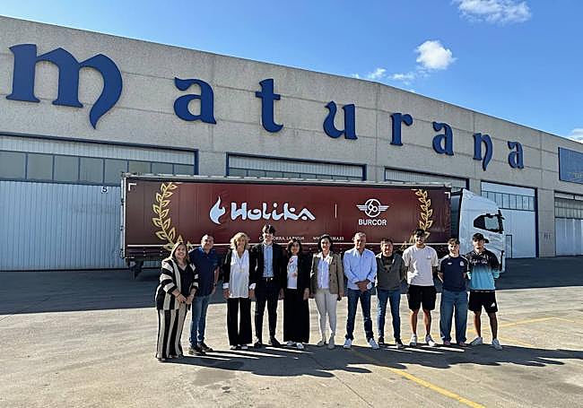 El camión rotulado que recorre España y miembros de la organización.