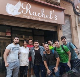 Raquel, en su tienda, junto a sus hijos y varios voluntarios.