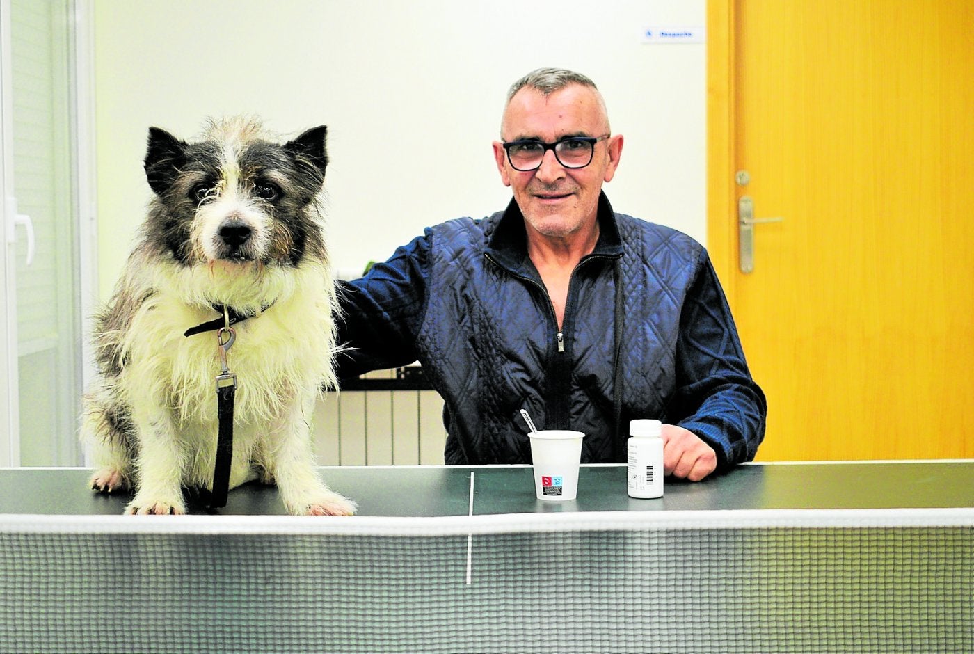 Félix posa con su perro Gucha en el centro Alasca, a donde acude a menudo a tomar café y también toma su medicación.