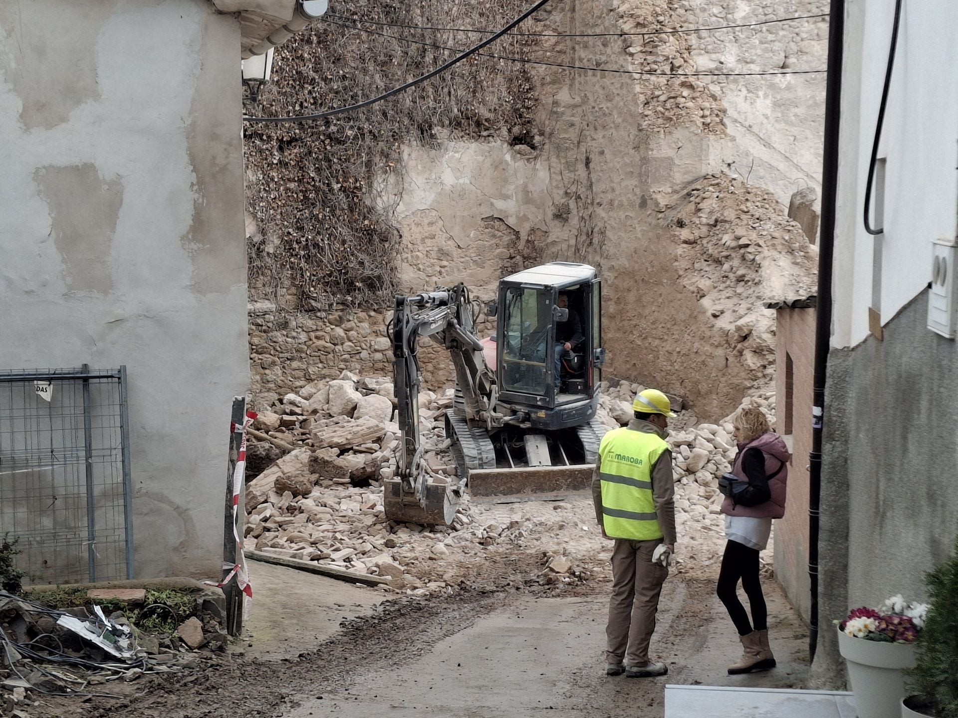 Una vecina habla con uno de los responsables de las labores de desescombro.