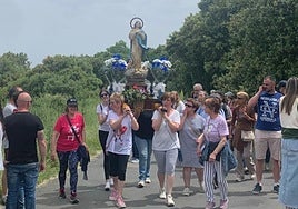 Un grupo de mujeres porta una imagen de la virgen.