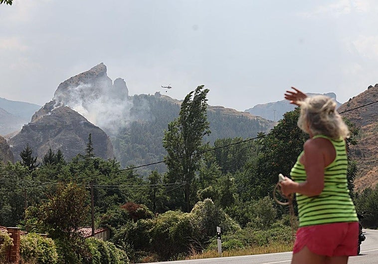 Una mujer observa observa el incendio declarar en El Peñueco.