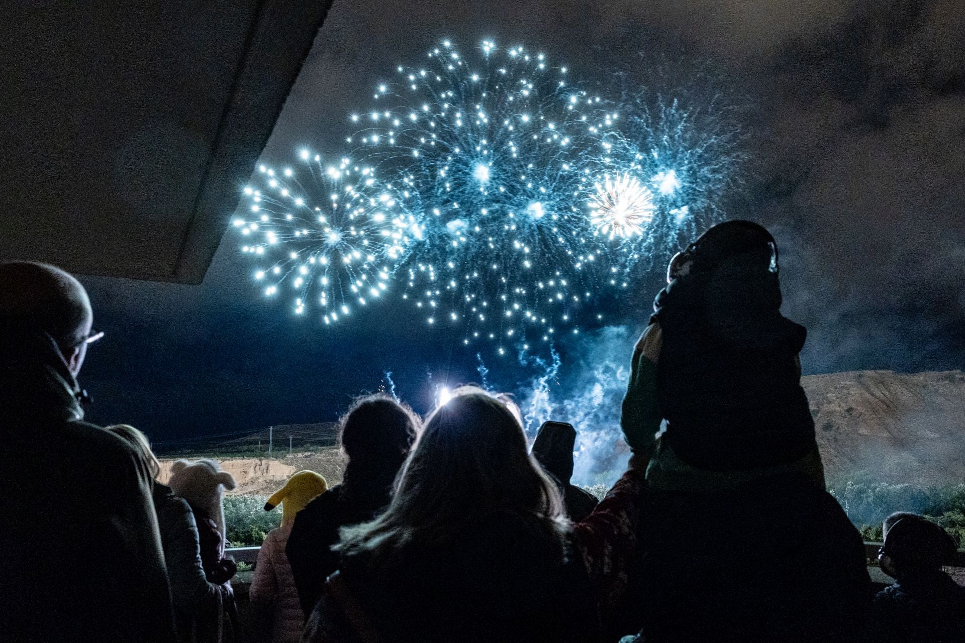 Imagen principal - Desde el paseo del Prior, Sonia Morga y otros vecinos disfrutan de los fuegos artificiales como si de un cine en el parque de La Ribera se tratase.
