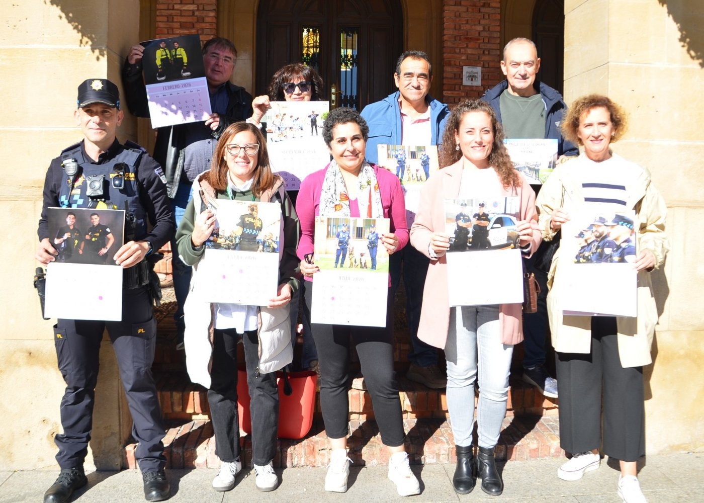 Representantes de la Policía, del Ayuntamiento, de la AECC, Asfocal y CMIK Fotografía, con el calendario.