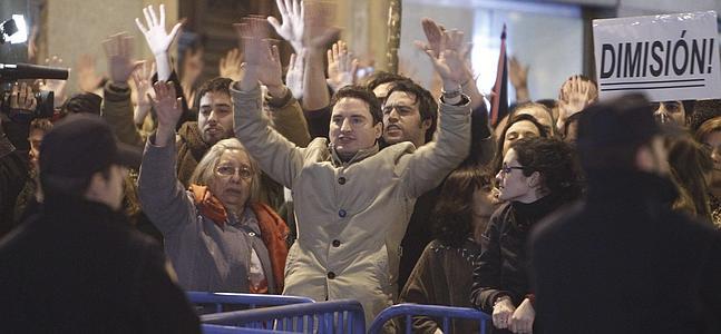 Manifestantes protestando frente a la sede madrileña del PP. / Ángel Díaz (Efe)