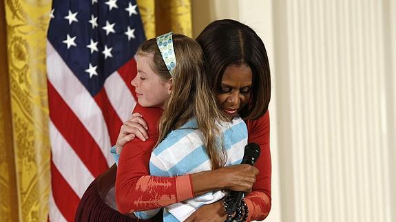 Michelle Obama abraza a la niña.