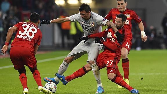 Mandzukic (c) intenta proteger el balón ante varios rivales. 