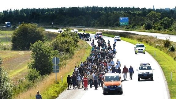 Refugiados sirios e iraquíes caminan por la E45 en dirección a Suecia. 