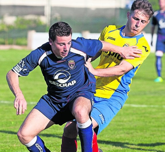 Santi y Luisja pugnan por el esférico. 