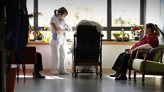 Una enfermera atiende a un paciente en un hospital. 