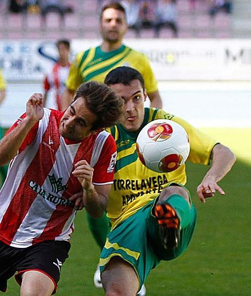 El jugador taniego Álex Santelices intenta evitar que un jugador del Zamora se lleve el balón.