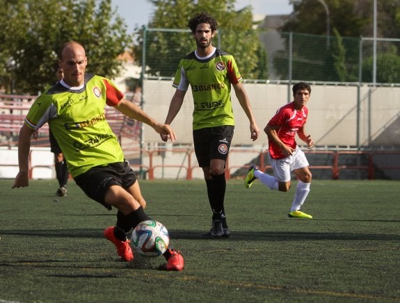 Sergio Domínguez conduce el balón ante la mirada de su compañero Gallardo. 