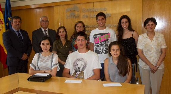 Isabel, Carlos y Ana en la recogida del premio. Detrás, sus familiares con miembros del Club Rotario y el consejero de Educación. :: díaz uriel