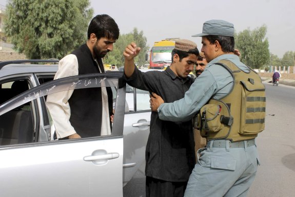 Un policía afgano practica registros en la ciudad afgana de Kandahar, de donde era originario el dirigente talibán Mohamed Omar. :: mohamed sadiq / efe