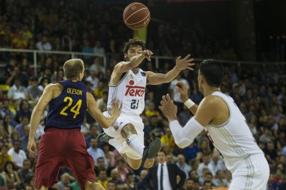 Llull juega el balón con Ayón ante el barcelonista Oleson. :: efe
