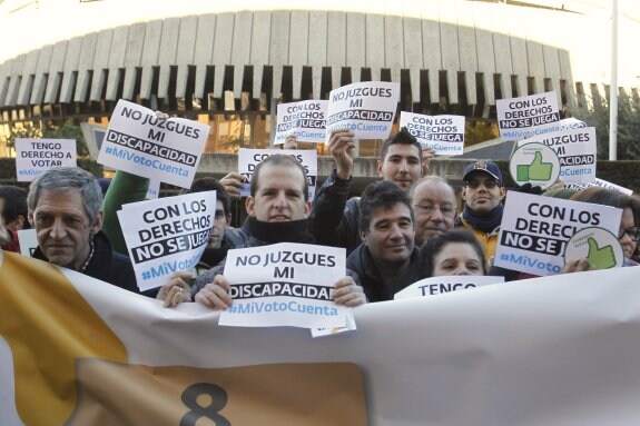 Discapacitados, familiares y miembros de sus asociaciones protestan, ayer, ante la sede del Tribunal Constitucional. :: Javier Tormo / EFE
