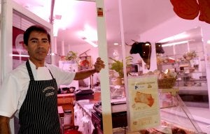 Miguel Ángel posa junto a la puerta de su carnicería desde donde interceptó al tironero cuando éste se daba a la fuga. ::                             MIGUEL HERREROS