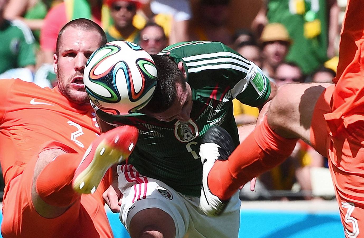 Stefan de Vrij intenta golpear la carrera mientra que Héctor Herrera pretende rematar de cabeza.