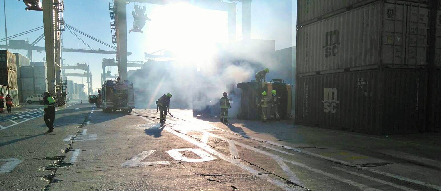 Un camión tráiler vuelca y se incendia en el Puerto de Valencia