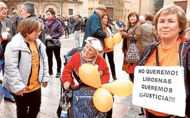 Dependientes y familiares en una protesta en la plaza de la Virgen de Valencia.