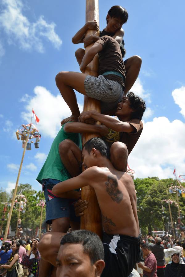 Tailanda celebra su Día de la Independencia de una manera muy peculiar: colocan en vertical los troncos talados de nogales que engrasan con aceite para dificultar la llegada a la cima en la que se encuentran varios premios. 