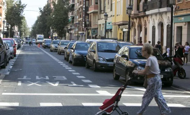 Carril de circulación lleno de coches en la calle de la Reina por la falta de aparcamientos. 