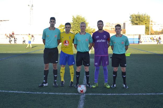 El capitán Raúl Muñoz, junto al trío arbitral y un futbolista del CD Dénia antes de que comenzara el partido en el Diego Mena. 